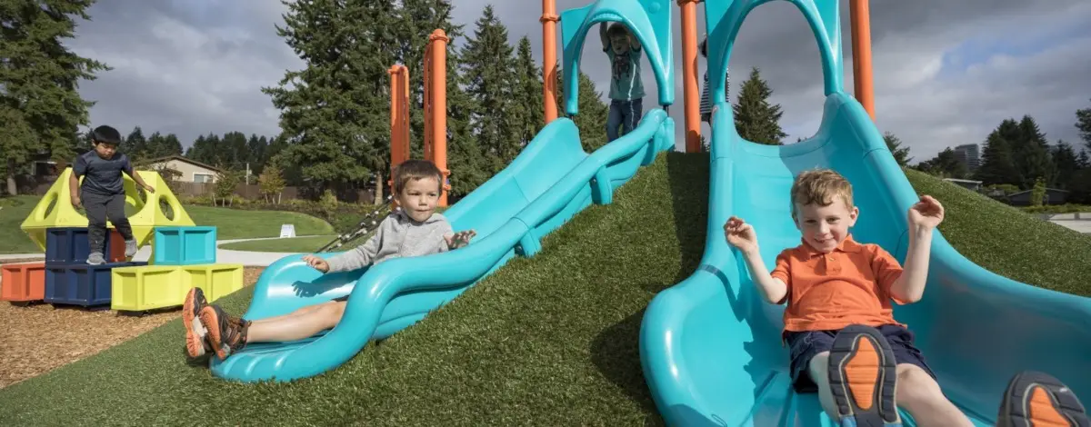 Children Enjoying Playground Slide